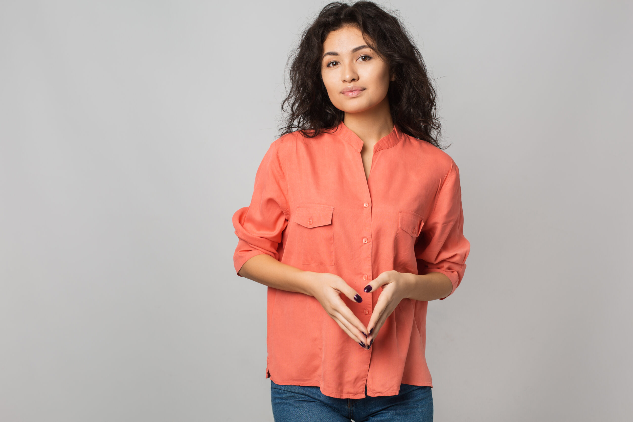 portrait of confident attractive young woman in stylish orange shirt smiling, casual summer style, brunette hair, isolated